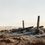 A stark hill outside Jerusalem with rough ground, subdued light, and the distant city under a solemn sky.